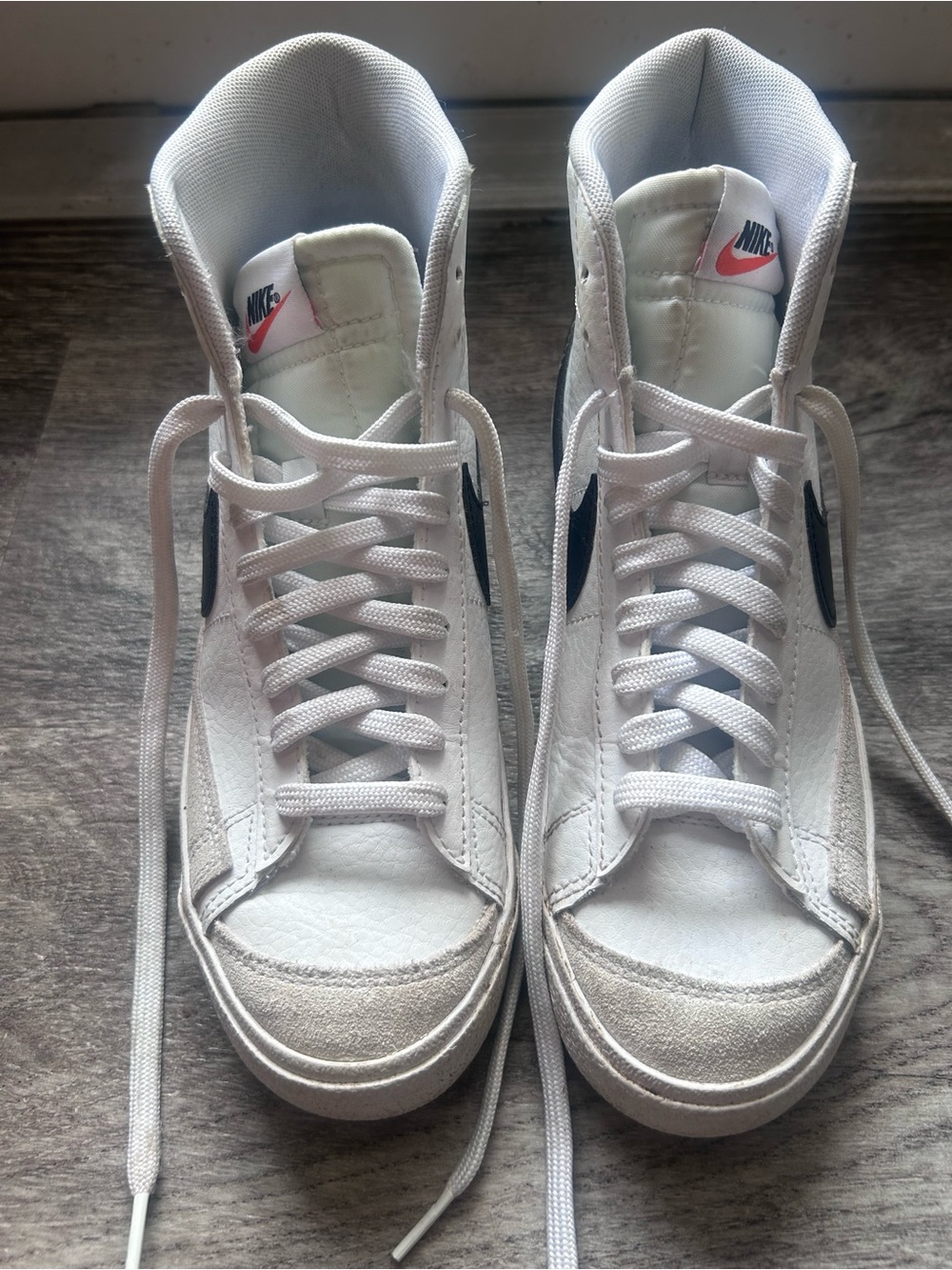 Nike White High-Top Sneakers with Black Swoosh and Pink Tongue Logo